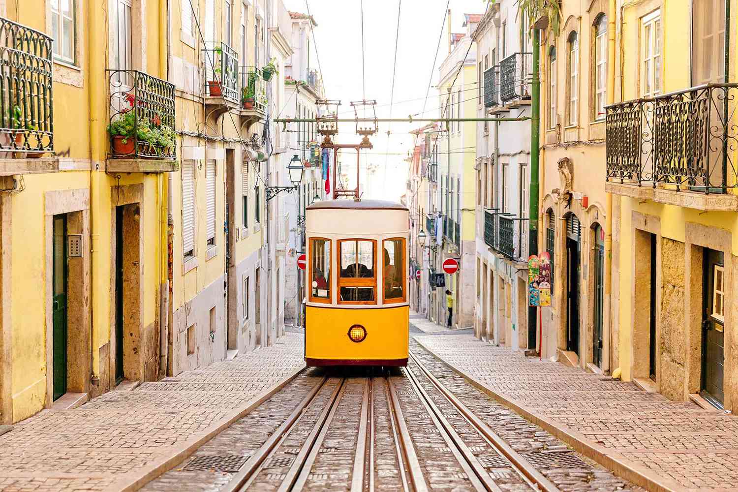 Yellow tram on a traditional street, Lisbon, Portugal