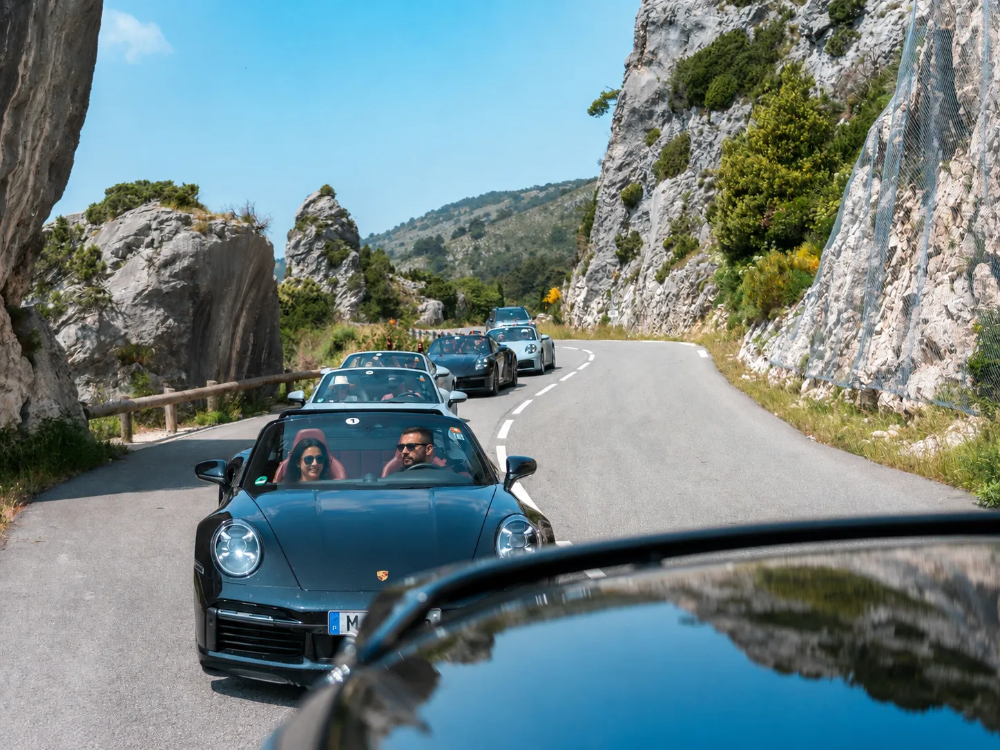 Porsche cars on a coastal road, South of France