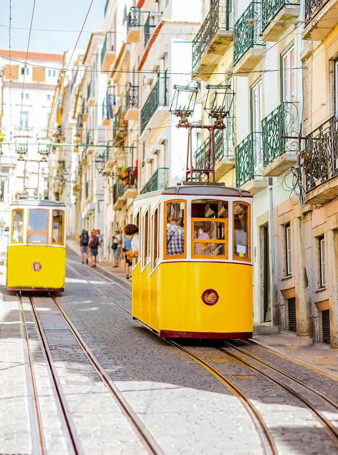 Lisbon's famous yellow funicular tram on a traditional street, Portugal